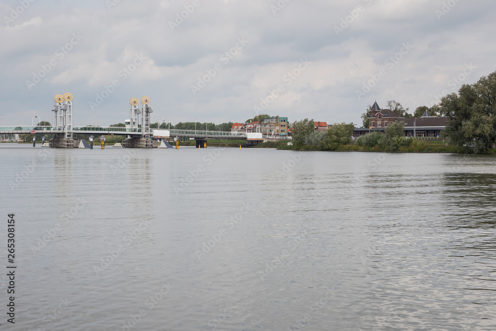 The train station with bridge over the Ijssel in Kampen, seen from the left shore