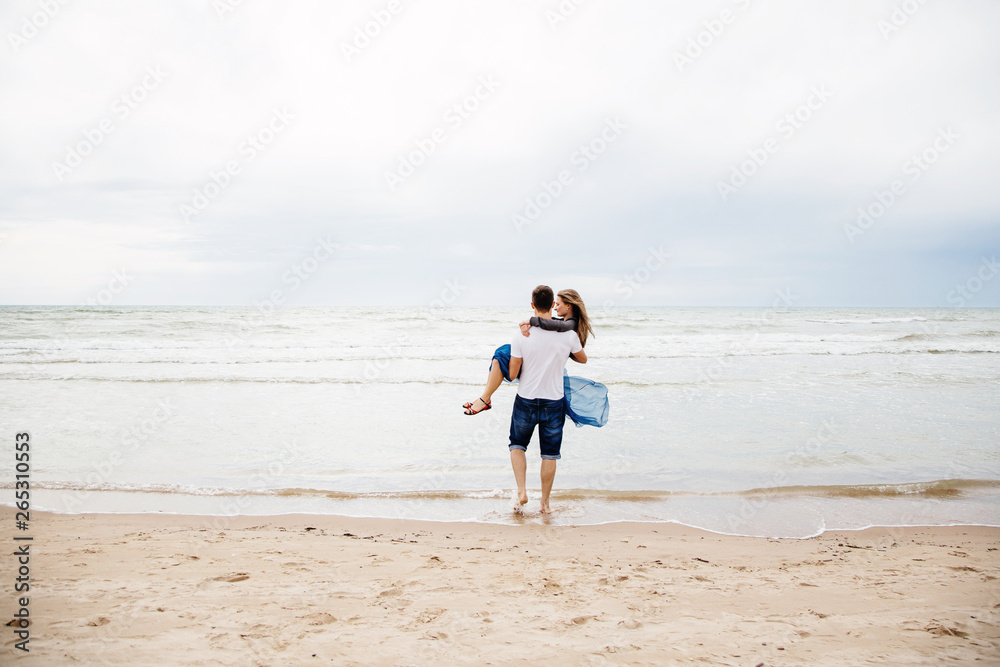 Young happy couple having fun on the beach..