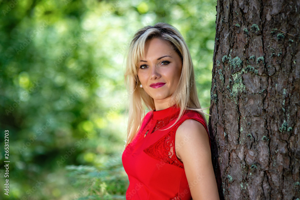 Beautiful, blonde woman portrait on a forest background. Beautiful, blonde woman portrait on a forest background.