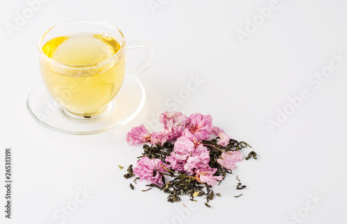 Fototapeta Naklejka Na Ścianę i Meble -  Cup of tea and pink cherry blossom on white background