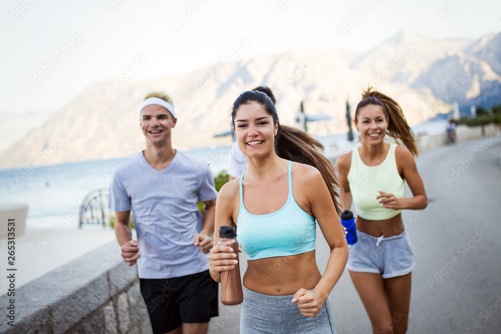 Friends fitness training together outdoors living active healthy Friends fitness training together outdoors living active healthy