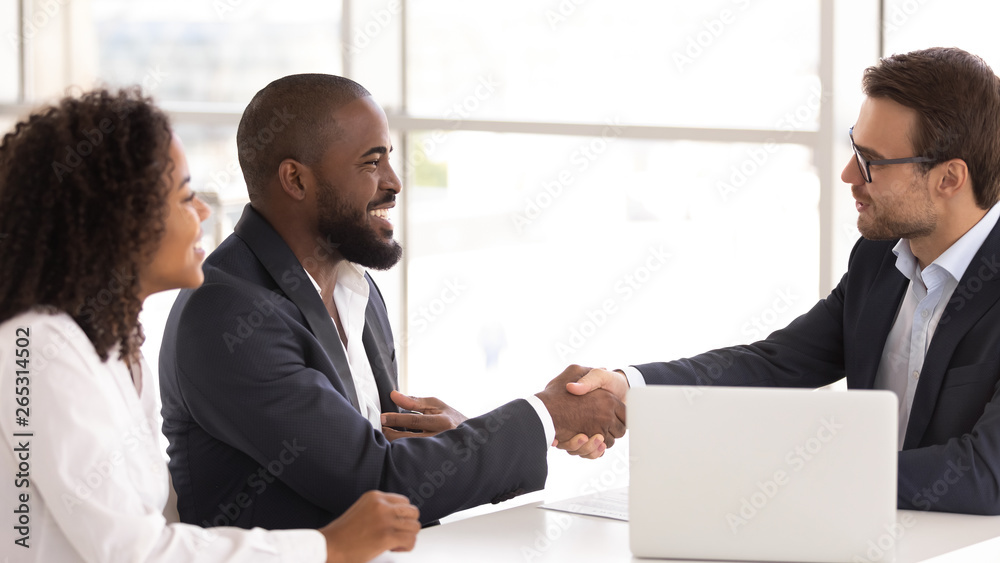 Happy african couple shake hand of insurer buy insurance services Happy african couple shake hand of insurer buy insurance services