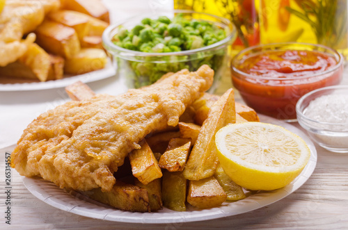 Obraz na płótnie Traditional British street food fish and chips with ketchup sauce and mushy peas on paper plate w salonie