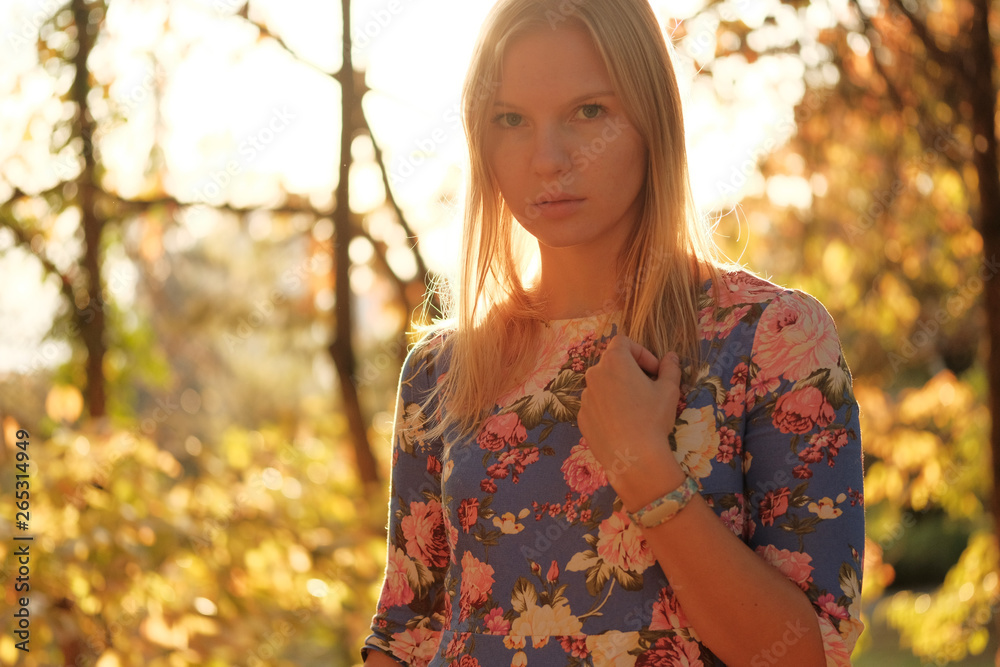 Beautiful russian girl posing for photo in park at sunny day Beautiful russian girl posing for photo in park at sunny day