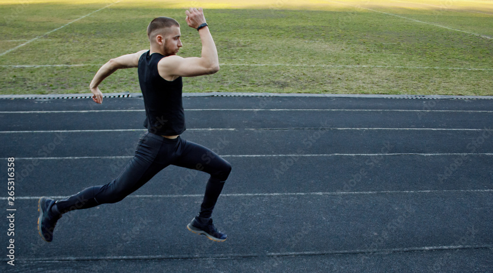 one caucasian male is doing a sprint start. running on the rubber track. Track and field runner in sport uniform. energetic physical activities. outdoor exercise, healthy lifestyle. running jumps one caucasian male is doing a sprint start. running on the rubber track. Track and field runner in sport uniform. energetic physical activities. outdoor exercise, healthy lifestyle. running jumps