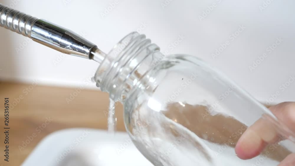 zero waste lifestyle concept. fill of purified water a reusable glass bottle zero waste lifestyle concept. fill of purified water a reusable glass bottle