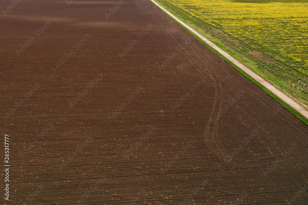 Aerial view of plowed field from drone pov Aerial view of plowed field from drone pov