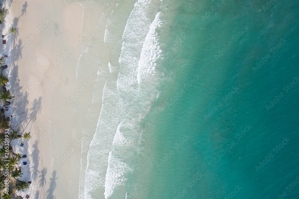Aerial view, tropical beach, top view of the waves on the beautiful sand beach