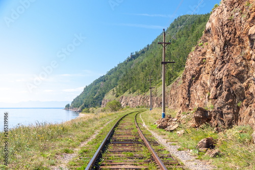 Railway tracks in nature in the mountains near the blue lake