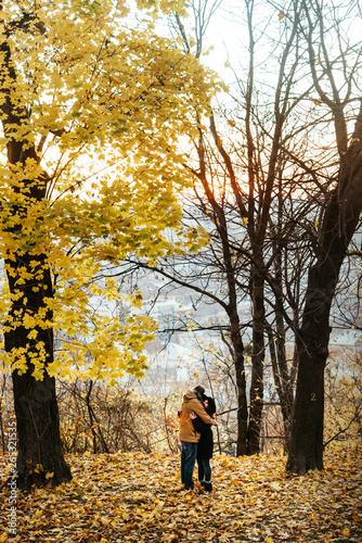 Fototapeta Naklejka Na Ścianę i Meble -  attractive happy luxury couple walking and holding hands in autumn colorful park
