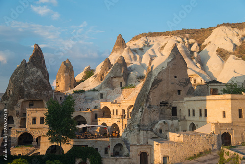 Dwellings in rocks of Cappadocia. Blue sky in background.