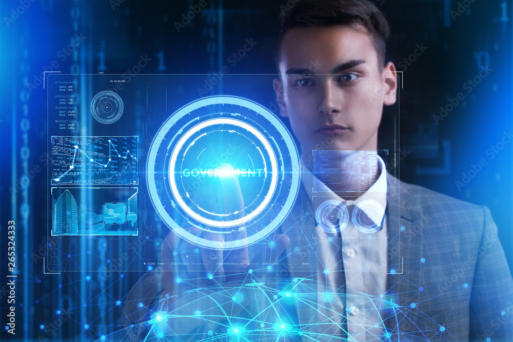 The concept of business, technology, the Internet and the network. A young entrepreneur working on a virtual screen of the future and sees the inscription: Government The concept of business, technology, the Internet and the network. A young entrepreneur working on a virtual screen of the future and sees the inscription: Government