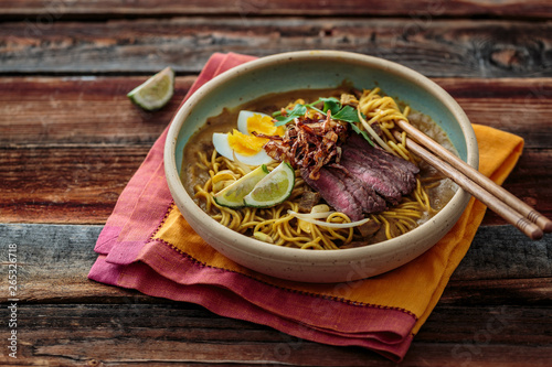 Billede på lærred Malaysia Spicy Noodle Mee Rebus With Beef Egg and fried onion, copy space