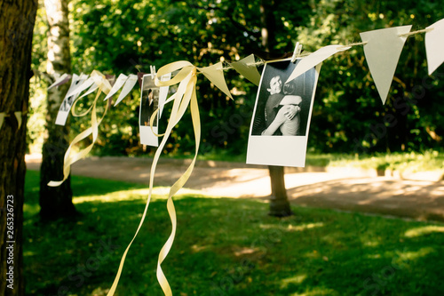 Stampa su Tela photos of couple and ribbons hanging at celebration place, handmade adorning and
