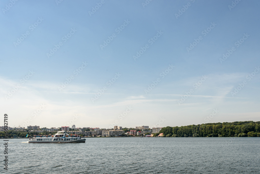 luxury cruise liner sailing at sunny lake at the city, summer vacation concept