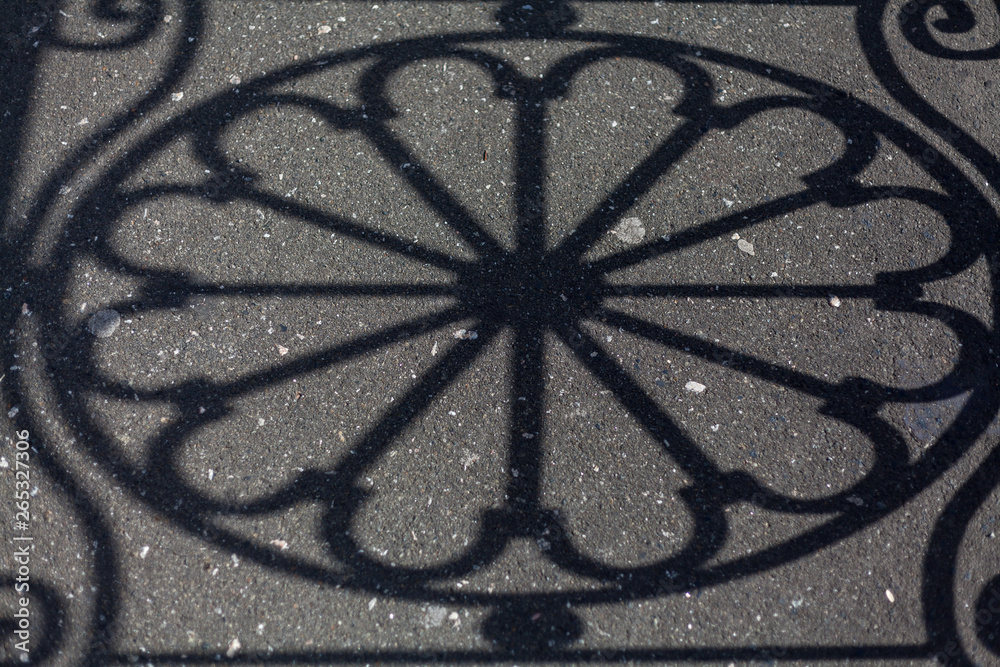 Shadow of  round design on asphalt