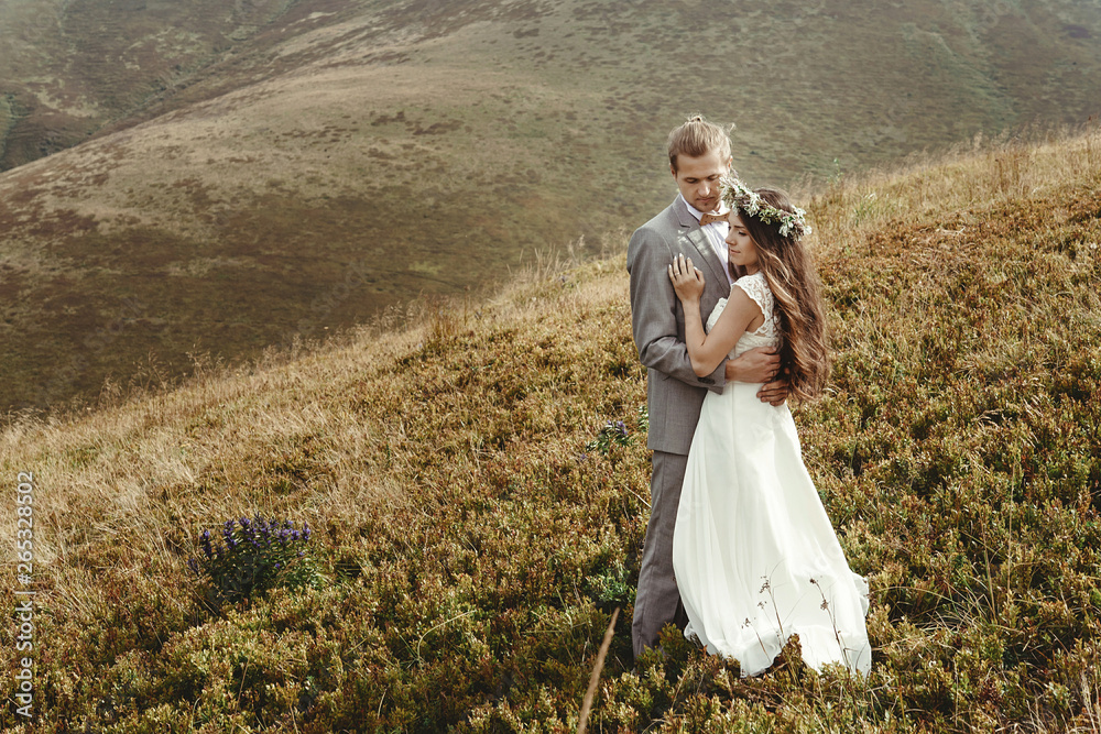 happy gorgeous bride and groom hugging in sun light, boho wedding couple, luxury ceremony at mountains with amazing view, space for text happy gorgeous bride and groom hugging in sun light, boho wedding couple, luxury ceremony at mountains with amazing view, space for text