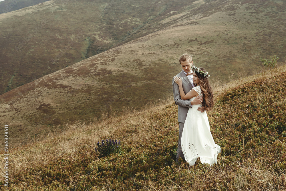 happy gorgeous bride and groom hugging in sun light, boho wedding couple, luxury ceremony at mountains with amazing view, space for text happy gorgeous bride and groom hugging in sun light, boho wedding couple, luxury ceremony at mountains with amazing view, space for text