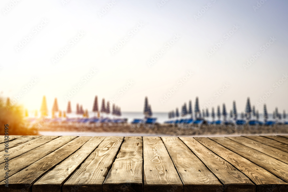 Table background of free space for your decoration and morning blurred background of beach and sea 