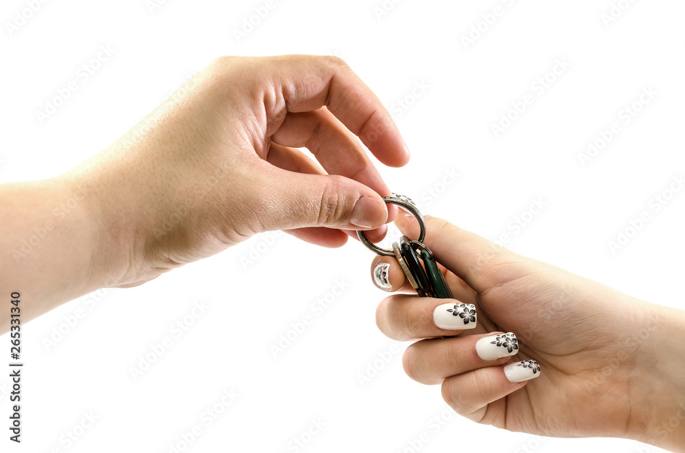 hand gives keys to hand on white background hand gives keys to hand on white background