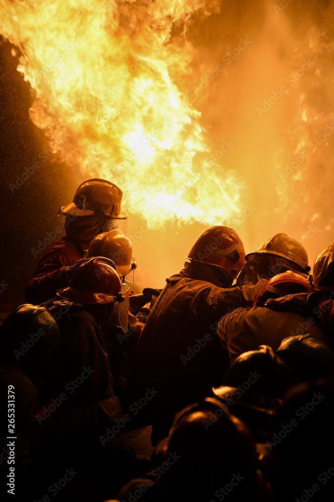 firefighters fight against fire burning 
