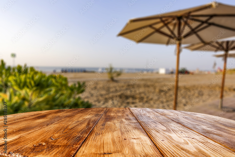 Table background of free space for your decoration and morning blurred background of beach and sea Table background of free space for your decoration and morning blurred background of beach and sea