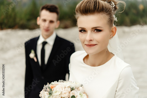 happy bride and stylish groom posing and smiling, luxury elegant wedding