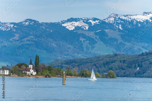 Early spring scenery with sailboats on the shores of the Upper Zurich Lake near Rapperswil, Sank Gallen, Switzerland photo