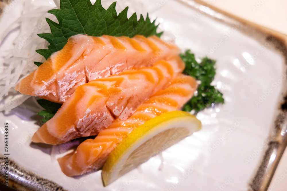 Fresh salmon belly sashimi served on plated in Japanese restaurant