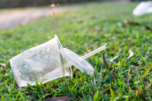 PVC cups litter on public park pose danger to environment photo