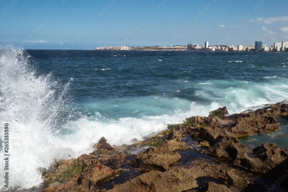 Waves crashing over the sea wall in Havana