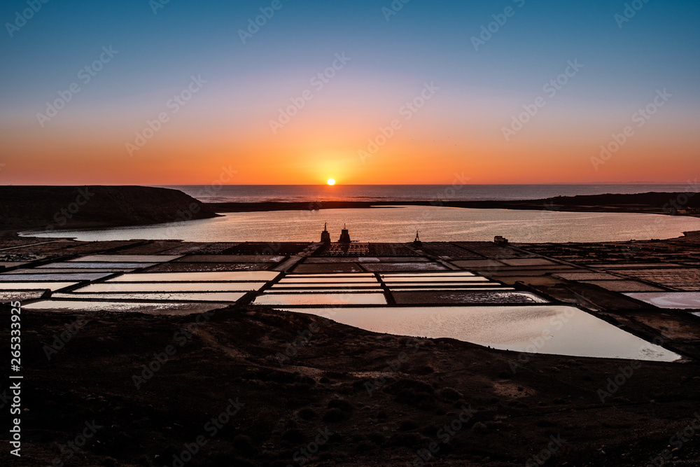 Naklejka premium Sunset at Salinas de Janubio. Old salt pans in the south of Lanzarote were they harvest salt the traditional way
