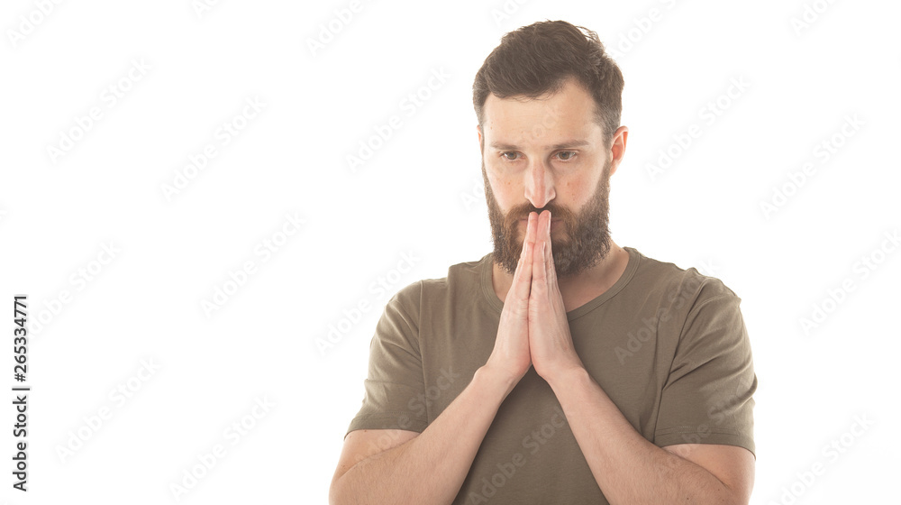 Picture of young bearded man dressed casually isolated on white background, having put hands together, dreaming and waiting for all best. Picture of young bearded man dressed casually isolated on white background, having put hands together, dreaming and waiting for all best.