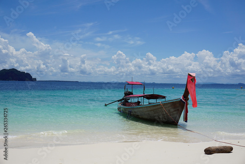 Longboat on the beach in Thailand Krabi with crystal clear water and white sand paradise isolation