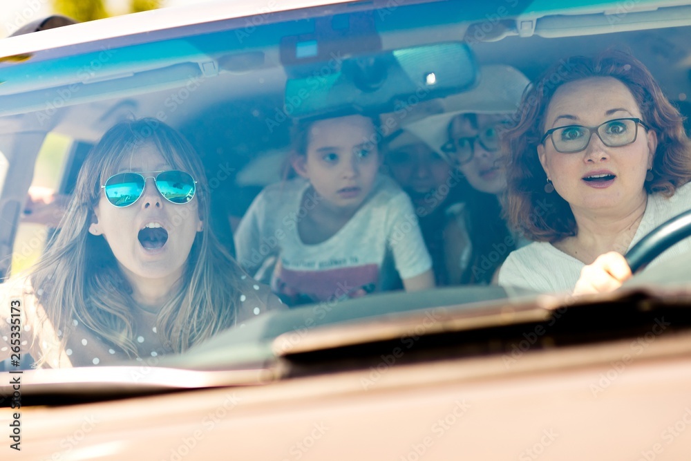 Mothers with daughters scared in car - frightened by incoming accident Mothers with daughters scared in car - frightened by incoming accident