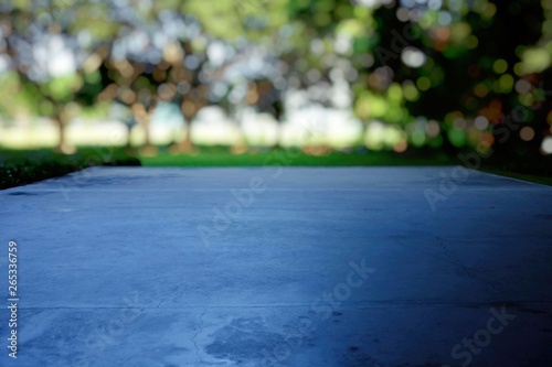 Close up Concrete Pavement with Blurred Park and Bokeh Background. (Selective Focus)