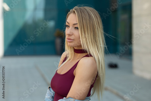 Beautiful smiling girl outdoor. A portrait of a beautiful blonde young Caucasian woman outdoor.