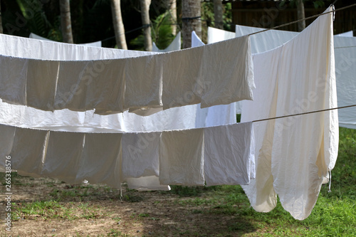 The white cloth is exposed to the sun on the clothesline.
