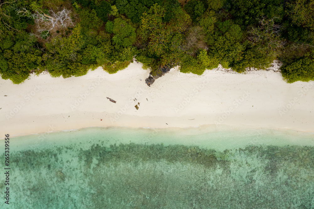 Obraz Aerial drone view of a deserted tropical island with beach and shallow coral reef (Stewart Island, Mergui Archipelago, Myanmar)