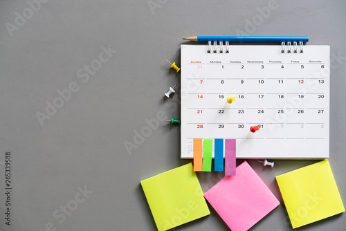 close up of calendar on the gray table, planning for business meeting or travel planning concept