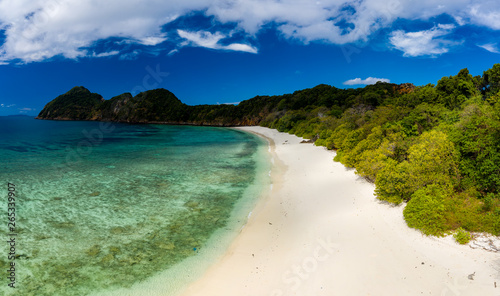 Aerial drone view of a deserted tropical island with beach and shallow coral reef (Stewart Island, Mergui Archipelago, Myanmar)