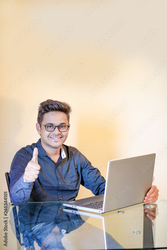 Young indian man with laptop Young indian man with laptop