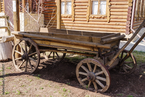 Old wooden horse carriage. Orenburg, Russia - April, 22, 2019: Horse-drawn carriage in the courtyard of a village house
