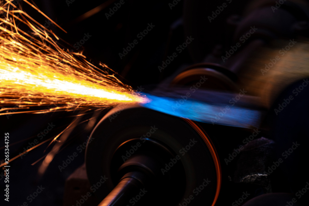 Fire sparks on a black background during workers sharpen a knife. Fire sparks on a black background during workers sharpen a knife.