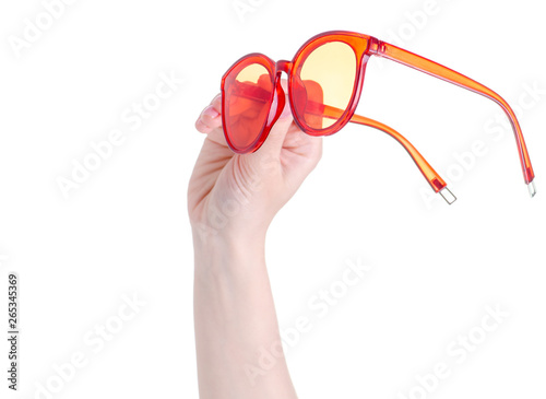 Red sunglasses in hand on white background isolation