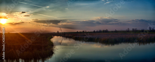 Sunset on the river in the Astrakhan region. Irrigation system for agriculture