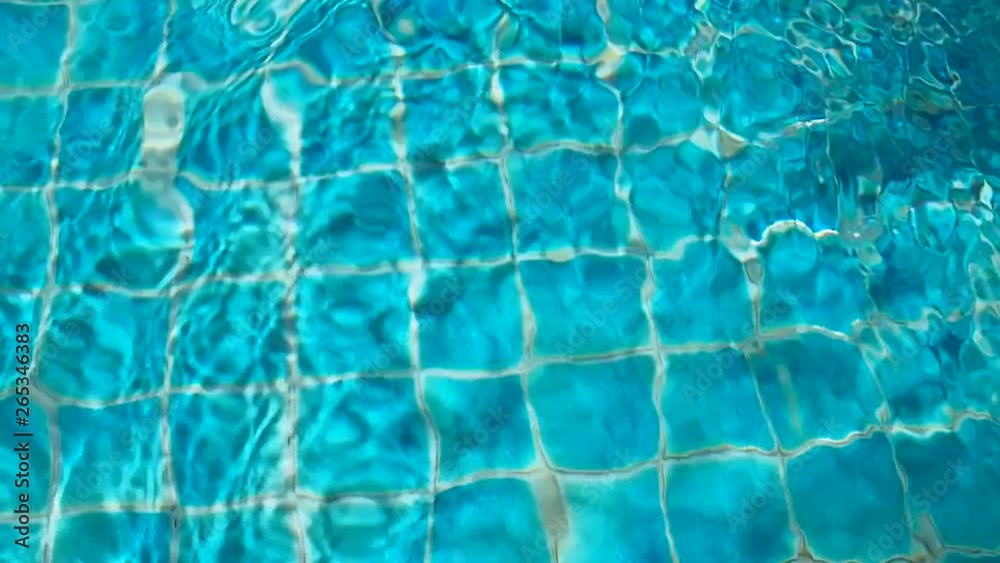 rippled water in blue tiles swimming pool; movement background rippled water in blue tiles swimming pool; movement background