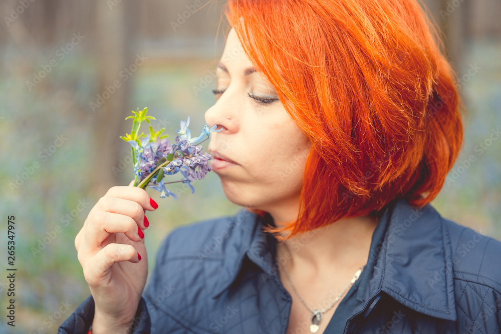 Young woman posing in park with flowers Young woman posing in park with flowers