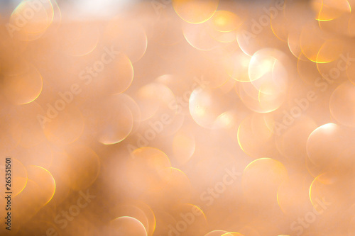 Christmas glowing Golden Background. Christmas lights. Gold Holiday New year Abstract Glitter Defocused Background With Blinking Stars and sparks. Blurred Bokeh photo