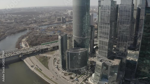 Aerial view on Moscow city skyscrapers and Moscow river. Sunny, blue sky, spring. Cars driving on the motorway.